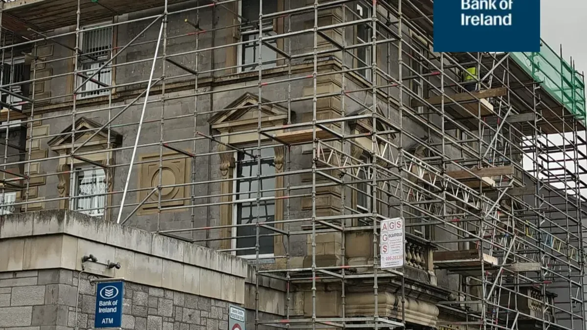Bank of Ireland building under scaffold during roofline and guttering works